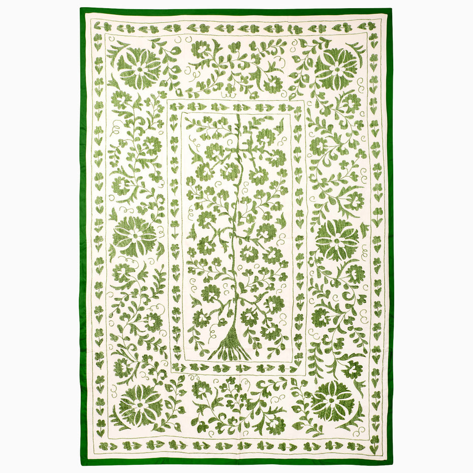John Robshaw Drawn In Thread Suzani Blanket, a rectangular throw with an off-white background, intricate botanical embroidery, vines, and a solid green border.