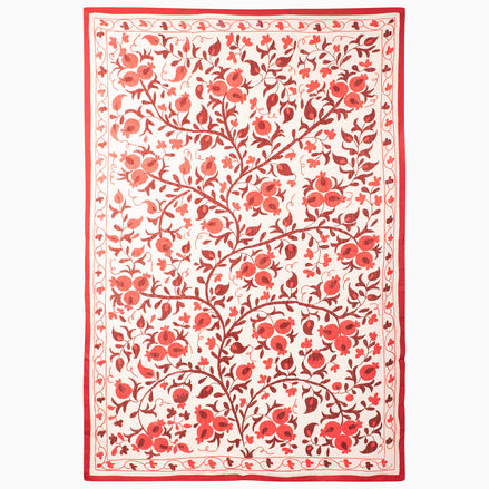 John Robshaw Harvest Poppy Suzani blanket in a rectangular, vintage style with a red-and-white botanical pattern of scrolling pomegranate vines and flowers enclosed by a solid red border.