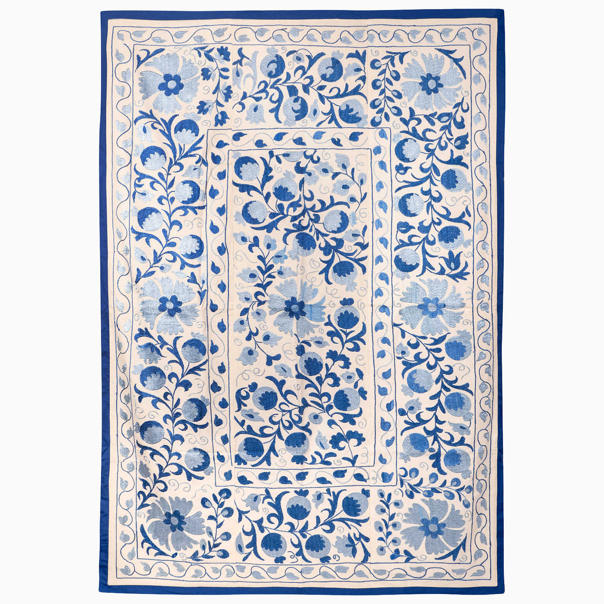 John Robshaw Indigo Sky Suzani Blanket featuring a rectangular off-white design with a repeating vintage blue floral border.