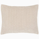 A soft beige Velvet Sand Quilt pillow, hand quilted by John Robshaw.