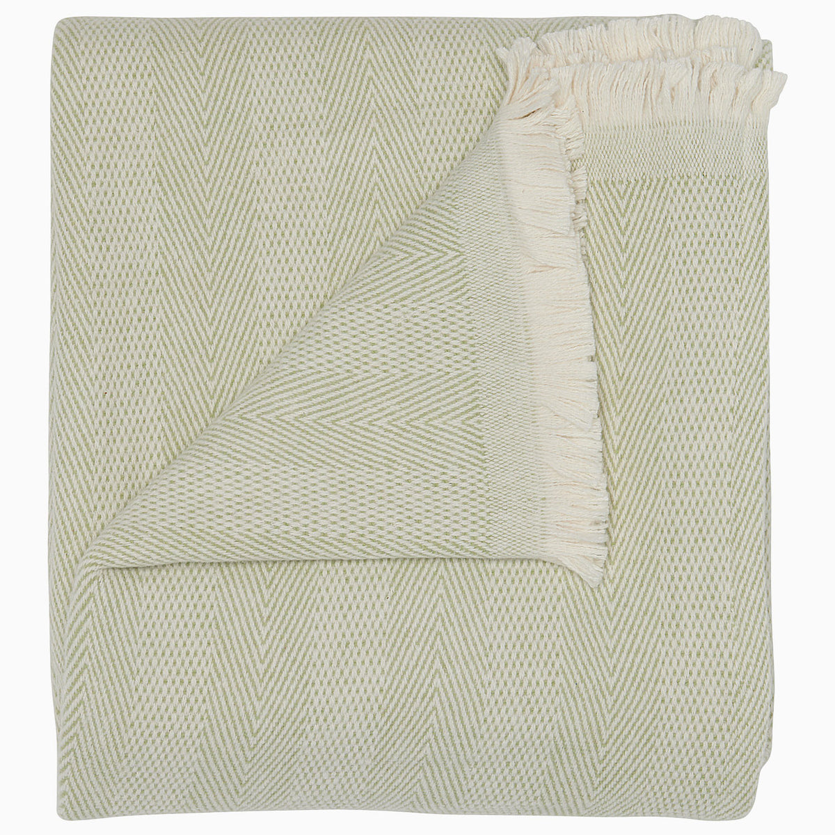 The Lavanya Sage Throw by John Robshaw is a folded, light cotton blanket featuring a subtle herringbone pattern and one fringed edge.