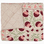 A pink and green Tejal Berry Throw by John Robshaw, with pomegranate flowers on it, featuring diamond pattern stitching. - 30395669708846