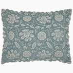 The John Robshaw Kimari Mist Coverlet showcases a blue background adorned with delicate woven florals, crafted from soft jacquard cotton chenille and finished with scalloped edges.