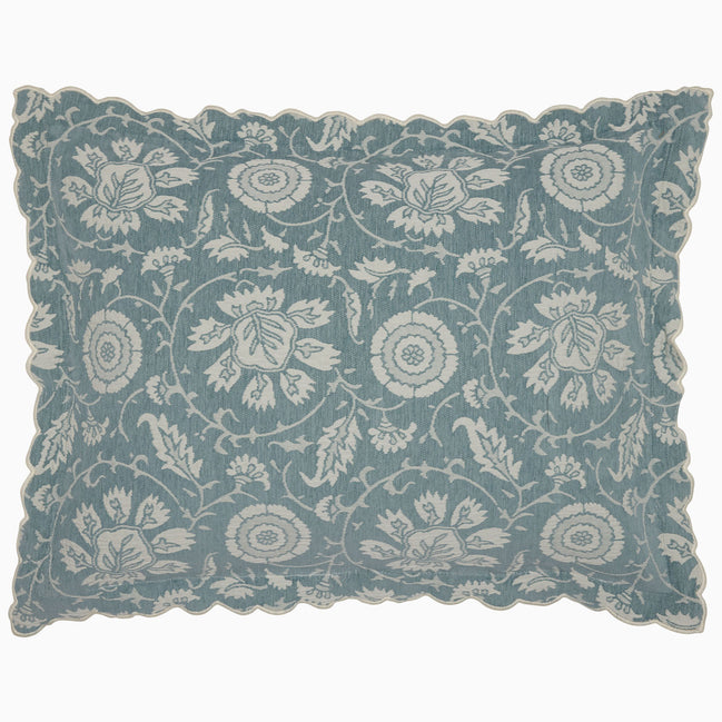 The John Robshaw Kimari Mist Coverlet showcases a blue background adorned with delicate woven florals, crafted from soft jacquard cotton chenille and finished with scalloped edges.