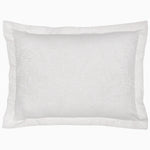 A decorative rectangular white pillow, part of the Amina Ecru Duvet Set by John Robshaw, featuring intricately woven lines and subtle floral patterns, crafted from the finest quality cotton linen. - 31272364212270
