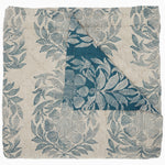 The Asma Peacock Woven Quilt by John Robshaw is a hand-quilted fabric square featuring an off-white background with a teal floral design, partially folded to showcase the reversible print on both sides. - 31272419917870