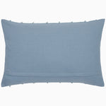 The Fringed Light Indigo Kidney Pillow by John Robshaw is a hand-sewn, rectangular pillow featuring a smooth surface and slightly fringed edges. - 31272474542126