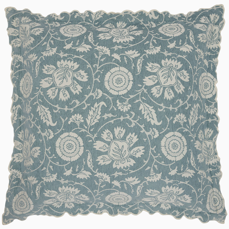 Square pillow featuring delicate woven florals in blue and white with scalloped edges, designed by John Robshaw as part of the Kimari Mist Coverlet collection, crafted from soft jacquard cotton chenille.