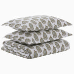 A stack neatly displays the Nilay Leaf Organic Duvet set by John Robshaw, which includes a paisley-patterned folded bedsheet set in green and brown, with two pillowcases and one 200 thread count fitted sheet. - 31272403599406