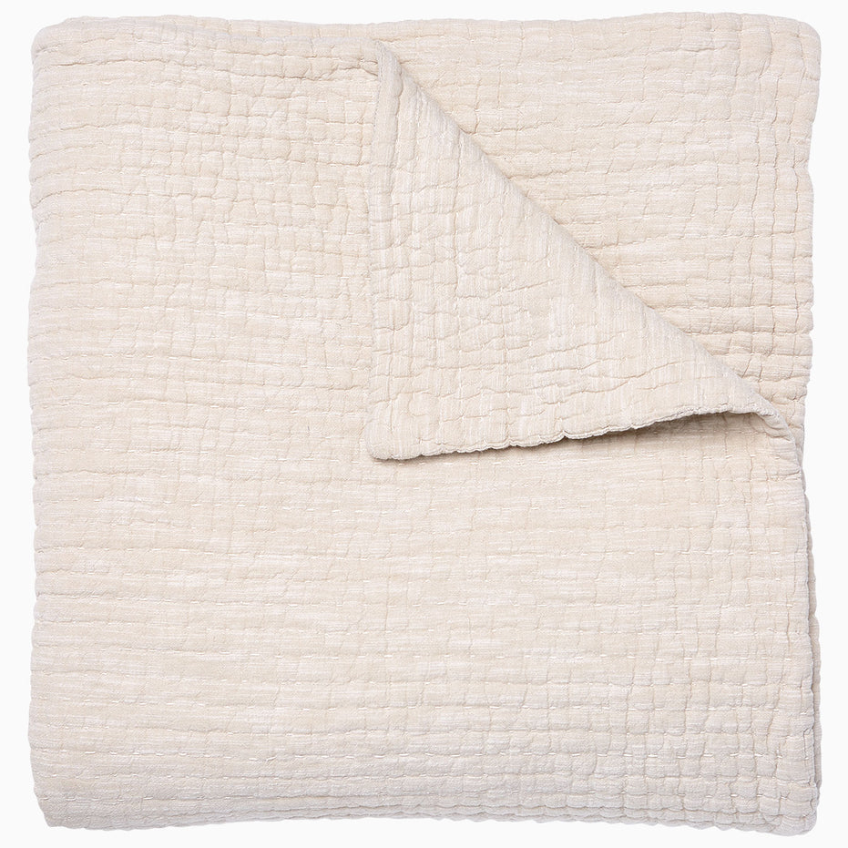 A Vivada Sand Woven Quilt, hand-stitched quilt, on a white background by John Robshaw.
