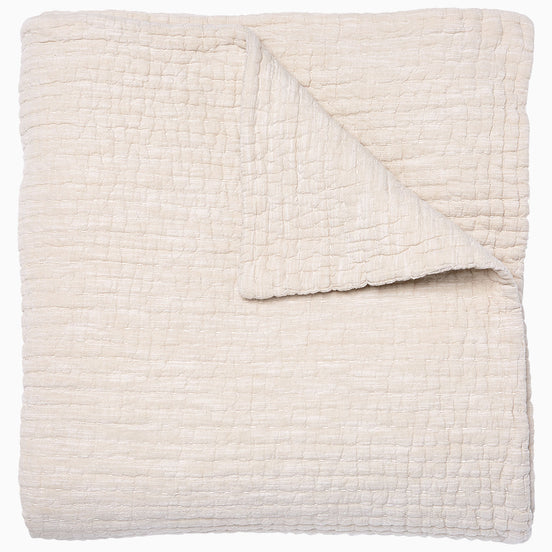 A Vivada Sand Woven Quilt, hand-stitched quilt, on a white background by John Robshaw.