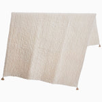 A hand-quilted white Velvet Sand Throw blanket with tassels, crafted by Indian artisans, made by John Robshaw. - 29302499377198