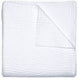 A Vivada White Woven Quilt by John Robshaw folded on top of a white surface with hand stitching.