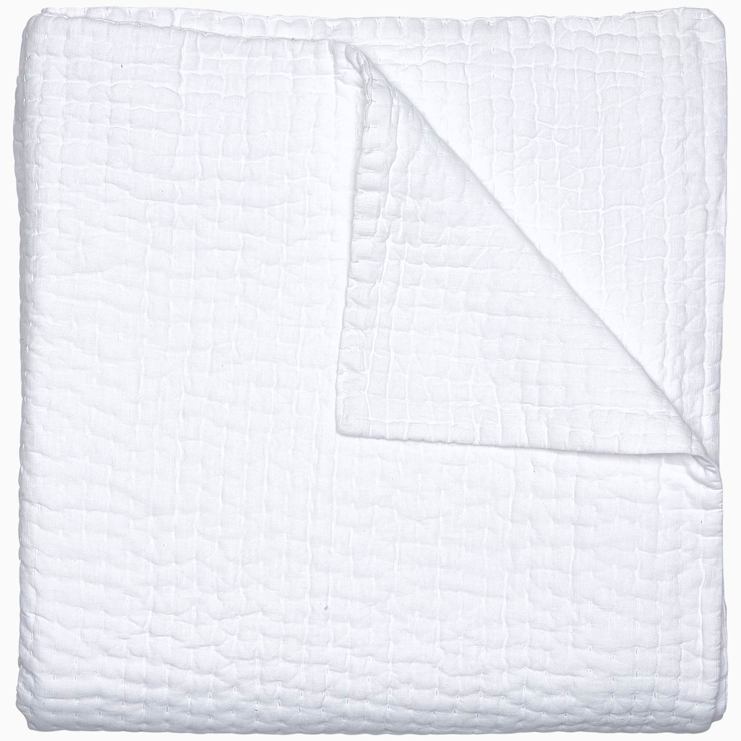 A Vivada White Woven Quilt by John Robshaw folded on top of a white surface with hand stitching.