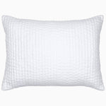 A Vivada White Woven Quilt pillow with hand stitching by John Robshaw.