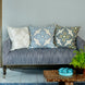 A Verdin Lapis Euro couch with John Robshaw blue pillows and a hand block printed potted plant.