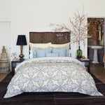A bedroom with a blue and white comforter featuring a John Robshaw Cinde Light Indigo Organic Sheet Set made from 100% cotton percale. - 29299613073454
