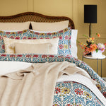 A bed with a John Robshaw floral comforter made of cotton and linen. - 30009700352046
