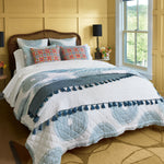 A cotton voile bed with a blue and white John Robshaw Lapis Peacock Quilt. - 30003015614510