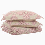 A stack of pink Dasati Lotus Duvet Sets in the John Robshaw colorway stacked on top of each other. - 28736039977006