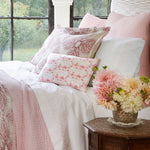 A bed with Stitched Blush Organic Sheets by John Robshaw featuring embroidered designs, prints, and made of organic percale cotton. - 28807124975662