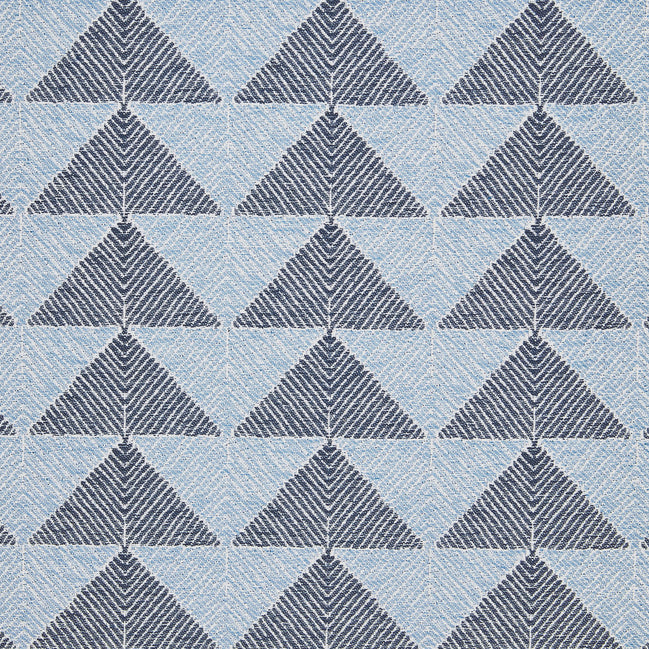 A Farzu Azure Performance Fabric rug with blue and white triangles on it by John Robshaw.