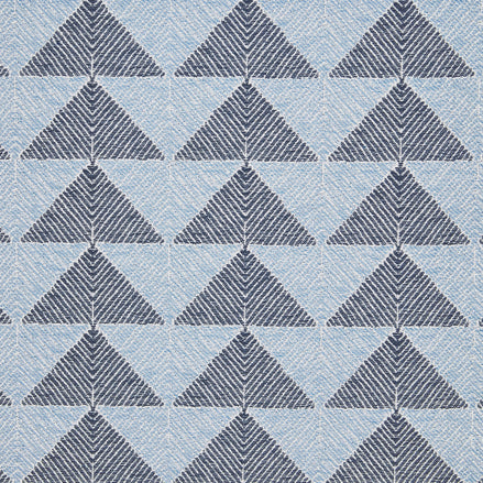 A Farzu Azure Performance Fabric rug with blue and white triangles on it by John Robshaw.