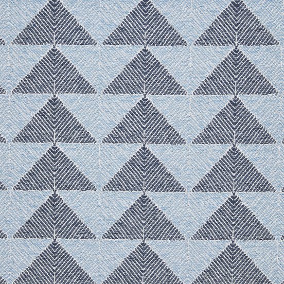A Farzu Azure Performance Fabric rug with blue and white triangles on it by John Robshaw.