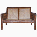 A vintage John Robshaw wooden and rattan loveseat with a cane bench. - 29225296527406
