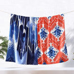 A blue and orange Malda Indigo beach towel, hand woven by skilled artisans, hanging on a clothesline. (Brand Name: John Robshaw) - 29274360741934