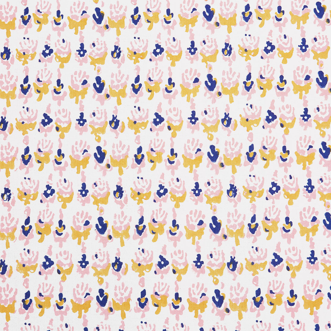 A close up of a Kiki Oyster Fabric hand block printed pink, blue and yellow flower batik by John Robshaw.