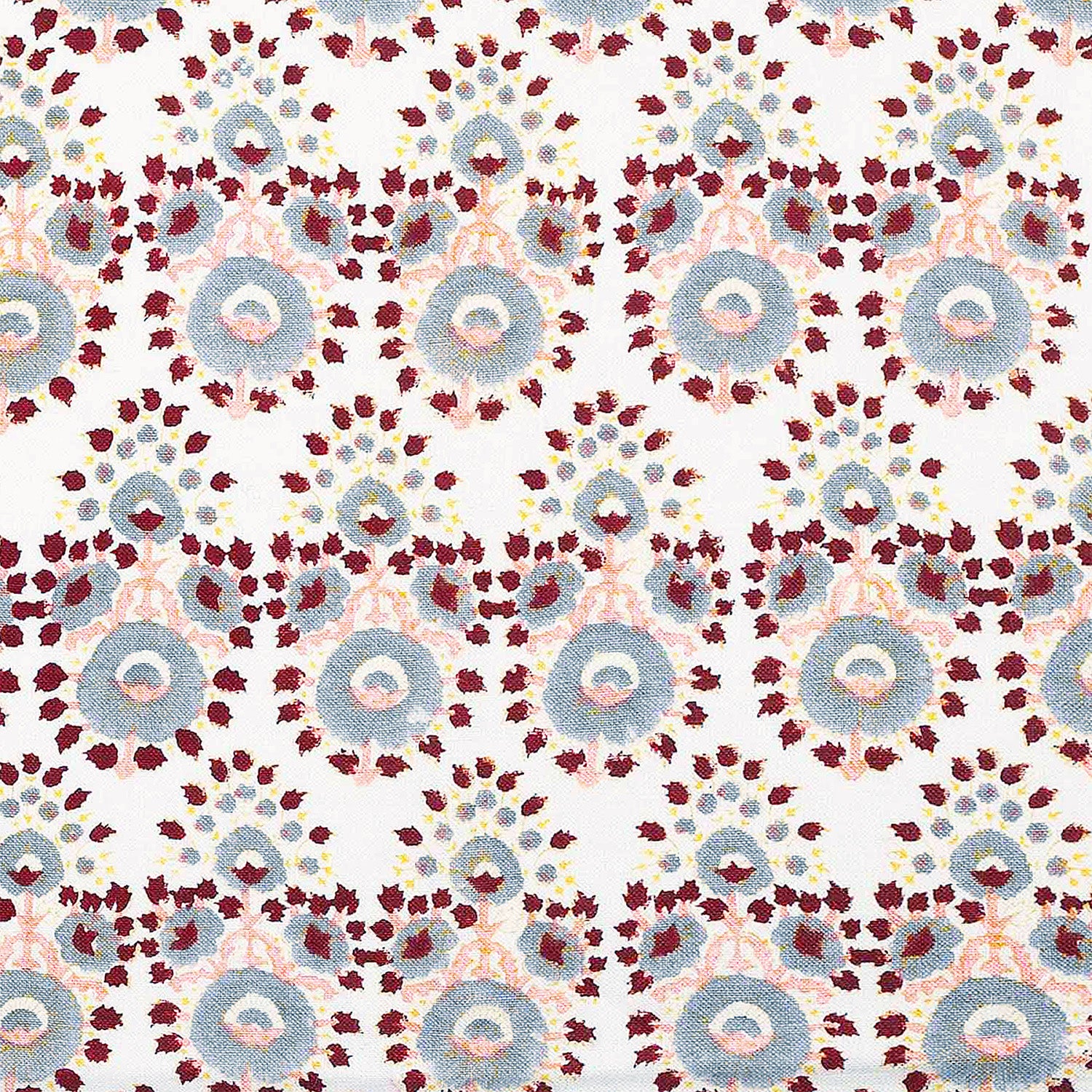 A hand block printed Lanka Oyster Fabric with a red, blue, and yellow pattern by John Robshaw.