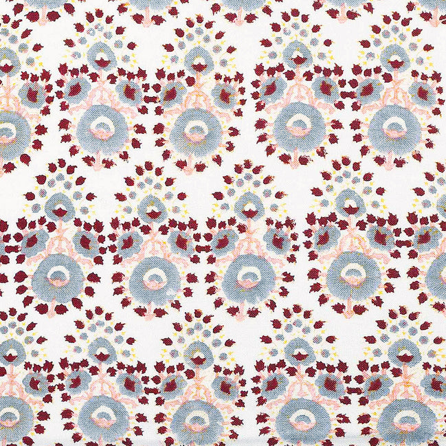 A hand block printed Lanka Oyster Fabric with a red, blue, and yellow pattern by John Robshaw.