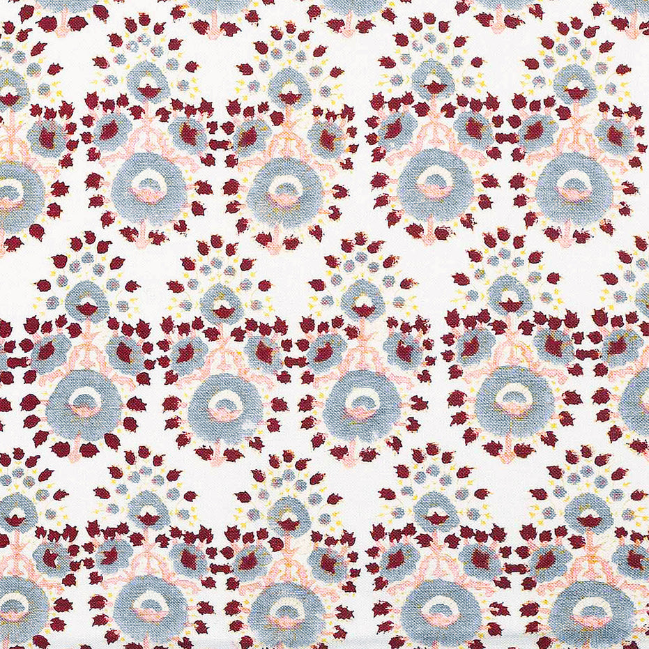 A hand block printed Lanka Oyster Fabric with a red, blue, and yellow pattern by John Robshaw.