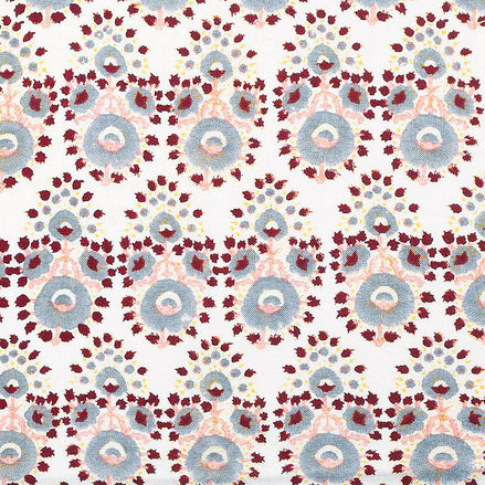 A hand block printed Lanka Oyster Fabric with a red, blue, and yellow pattern by John Robshaw.