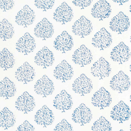 This Mali Light Indigo Fabric by John Robshaw showcases a beautiful blue and white tree pattern on a crisp white background, highlighting the traditional craftsmanship involved in creating this design.
