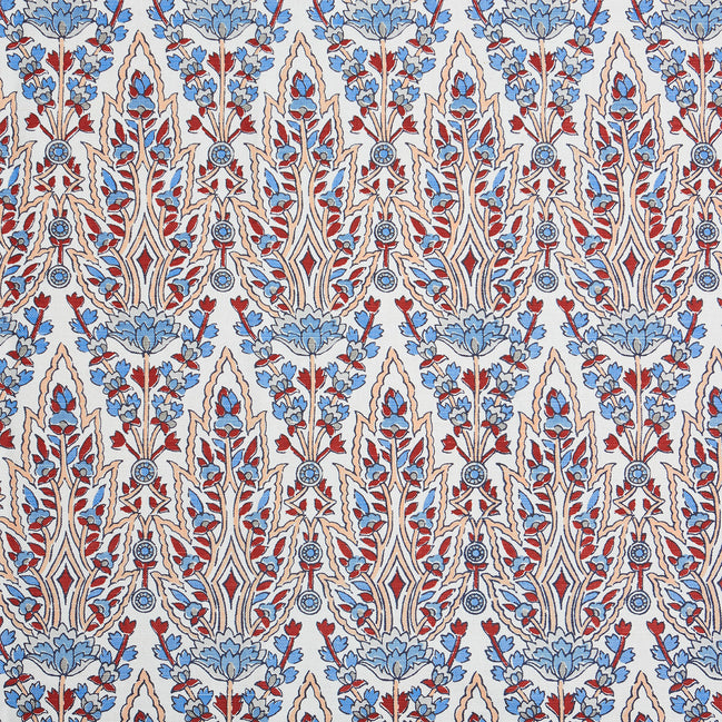 A beautiful blue and red floral pattern resembling the blooming gardens of Mughal, hand block printed on a pristine white background using the Marmar Coral Fabric by John Robshaw.