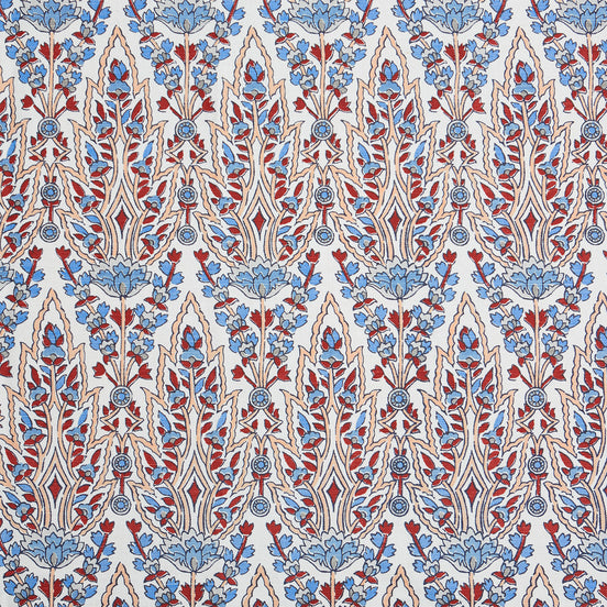 A beautiful blue and red floral pattern resembling the blooming gardens of Mughal, hand block printed on a pristine white background using the Marmar Coral Fabric by John Robshaw.
