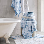 A blue and white bathroom with John Robshaw Pasak Blue Bath Towels and a tub. - 28268378488878