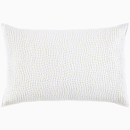 A white pillow with hand stitching and organic cotton voile coverlets, featuring the Organic Hand Stitched Sand Quilt by John Robshaw.