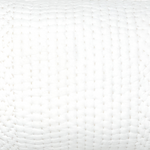 A close up image of a white quilted pillow with hand stitching and Sahati Sand bolsters by John Robshaw. - 14839376576558