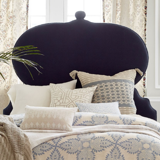 A bed with a Custom Orissa headboard and pillows by John Robshaw available for Free Shipping.
