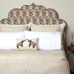 A white bed with a John Robshaw Two Elephants Decorative Pillow on it. - 30264082890798