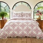 A bed with a pink and white floral pattern featuring the John Robshaw Dasati Lotus Duvet Set. - 28783107637294
