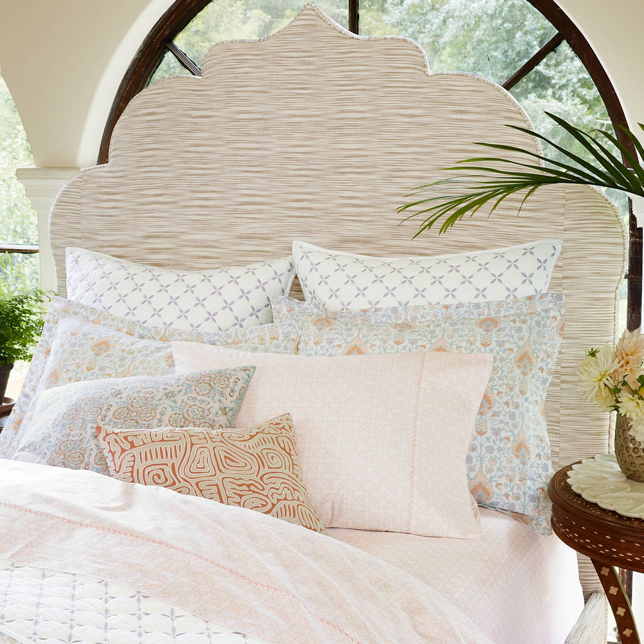 A pink and white Layla Lavender Quilt made of cotton voile, adorned with pillows, inspired by the Mughal gardens, and quilted for extra coziness. (Brand Name: John Robshaw)