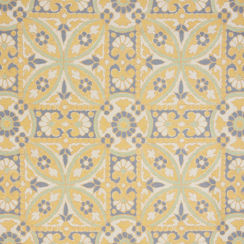 A John Robshaw Oman Marigold Fabric rug with an ornate design in yellow and blue.
