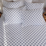 A bed with a Layla Indigo Quilt by John Robshaw, reminiscent of peaceful Mughal gardens. - 28783173173294
