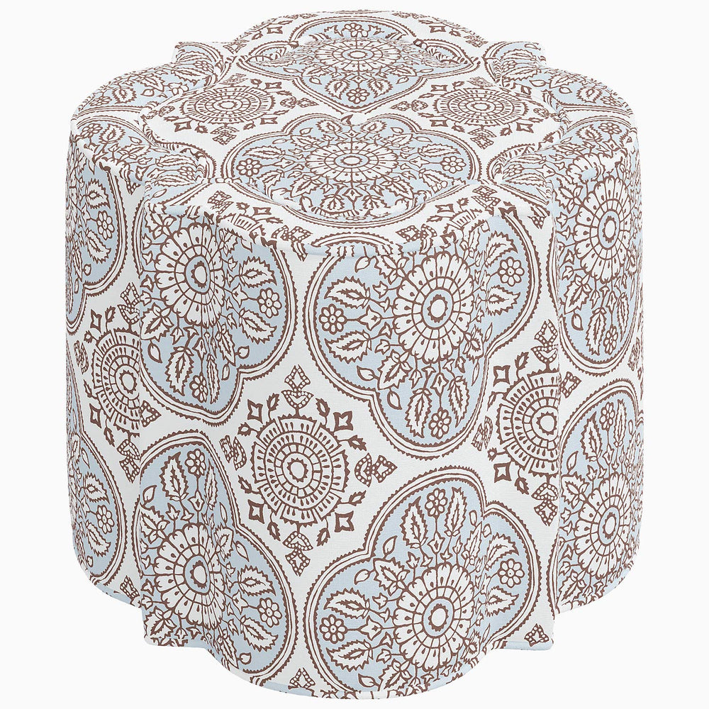 A Shiza Ottoman by John Robshaw, with a blue and brown pattern, perfect for interior design.