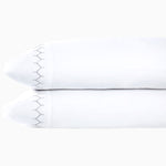 A pair of Stitched Gray Organic Sheets pillowcases featuring embroidered designs, showcased on a white background, by John Robshaw. - 30271863390254