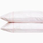 A pair of Poseti Lotus Organic Sheet Sets by John Robshaw, made with organic cotton, resting on a white background. These sheet sets are machine washable. - 30252461686830